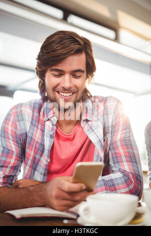 Smiling man using mobile phone Stock Photo