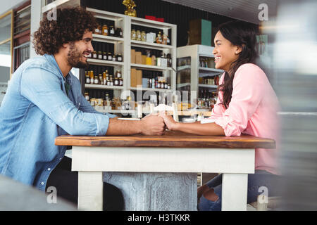 Couple holding hands and smiling Stock Photo