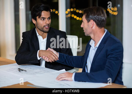 Businessmen shaking hands with each other Stock Photo