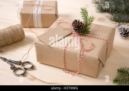 Christmas Gift Box with Tag, Mock-up. Craft Items Set. Wooden Background. Stock Photo