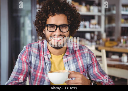 Portrait of man smiling while having coffee Stock Photo
