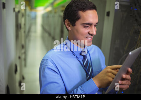 Technician using digital tablet in hallway Stock Photo