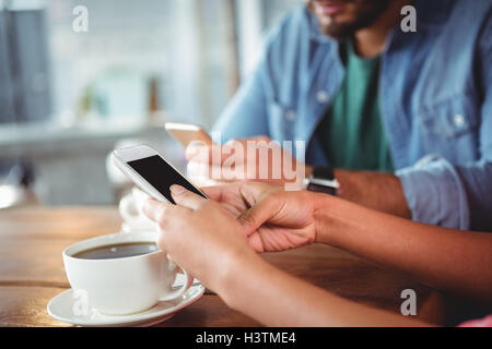Hands of couple using mobile phone Stock Photo