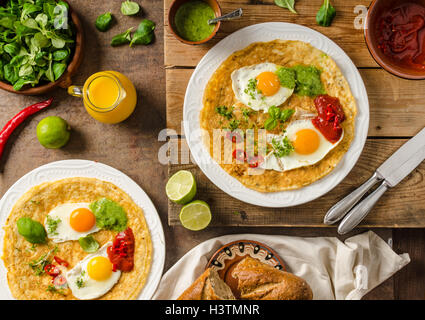 Huevos divorciados, delicious food with eggs, fresh salad and herbs and spicy and herby sauce Stock Photo