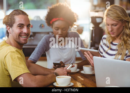Group of friends using mobile phone and laptop Stock Photo