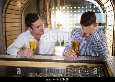 Man comforting his depressed friend Stock Photo