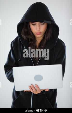 Hacker using a laptop Stock Photo