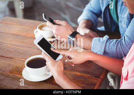 Hands of couple using mobile phone Stock Photo