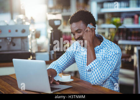 Smiling man talking on mobile phone Stock Photo