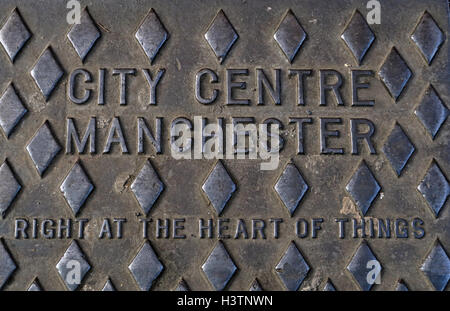 City Centre Manchester embossed cast iron Grid, Right at the heart of things, England UK Stock Photo