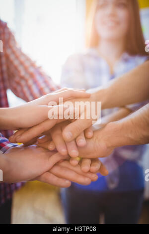 Creative business people stacking hands Stock Photo