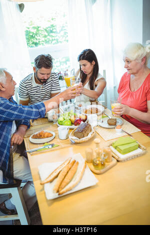 Happy couple having breakfast with their parents Stock Photo