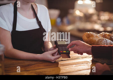 A customer entering her pin number in chip and pin machine Stock Photo ...