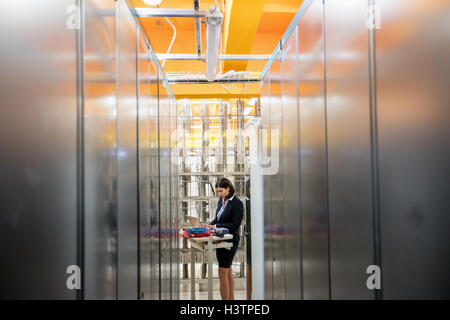 Technician working in server room Stock Photo
