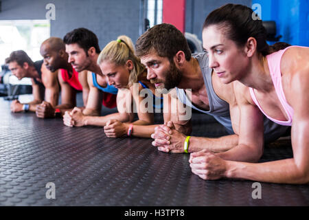Serious friends exercising in gym Stock Photo