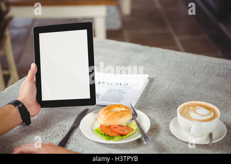 Hand of man holding digital tablet Stock Photo