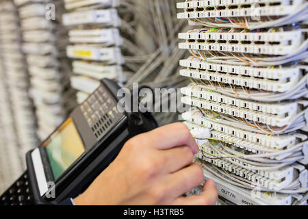 Technician using digital cable analyzer Stock Photo