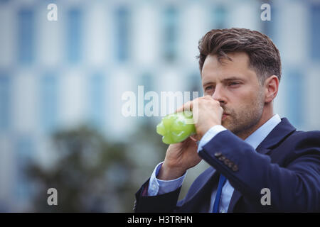 Close-up of businessman drinking juice Stock Photo