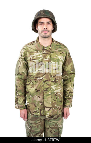 Portrait of confident military soldier standing against waving flag of ...