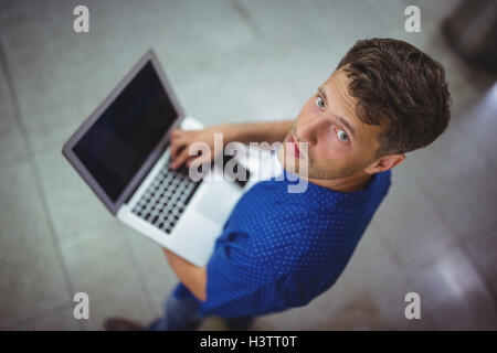 Portrait of handsome man using laptop Stock Photo