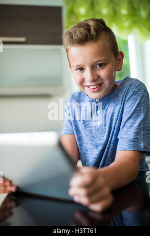 Portrait of boy using digital tablet Stock Photo