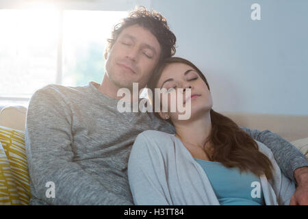 Couple sleeping together on sofa Stock Photo