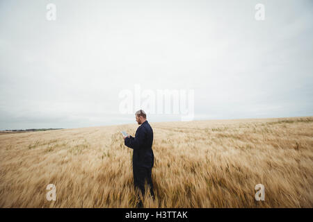 Farmer using digital tablet in the field Stock Photo
