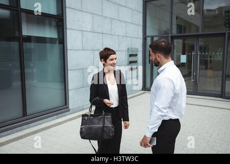 Businesspeople interacting with each other Stock Photo