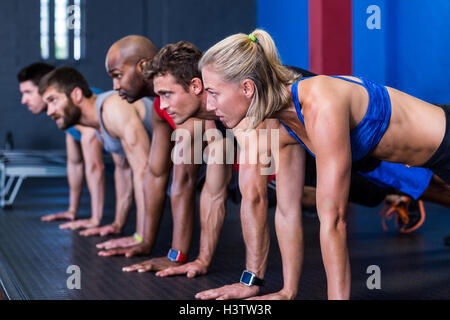 People doing push-ups in gym Stock Photo