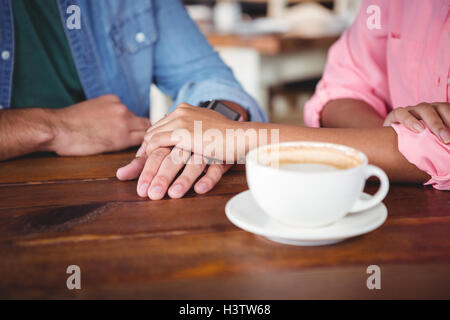Mid-section of couple holding hands Stock Photo