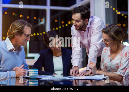Businesspeople discussing on documents in office Stock Photo