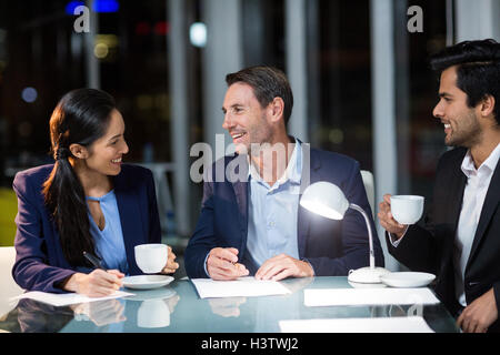 Group of businesspeople interacting with each other Stock Photo