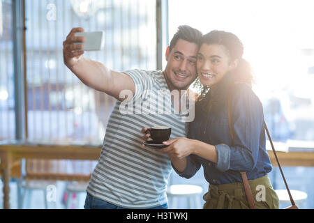 Young couple taking selfie in caf├⌐ Stock Photo
