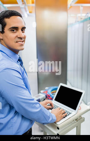 Portrait of technician working on laptop Stock Photo