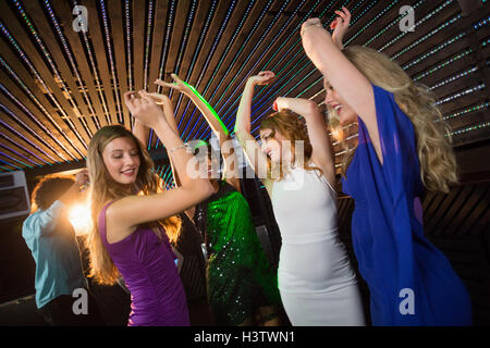 Group of smiling friends dancing on dance floor Stock Photo