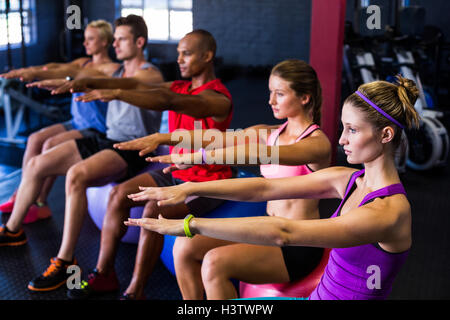 Friends doing stretching exercise Stock Photo