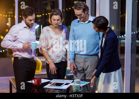 Businesspeople discussing on documents in office Stock Photo