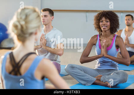 Instructor taking yoga class Stock Photo
