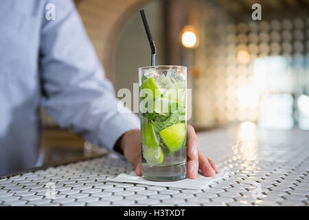 Close-up of man holding glass of gin Stock Photo