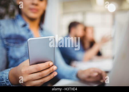 Businesswoman using mobile phone Stock Photo