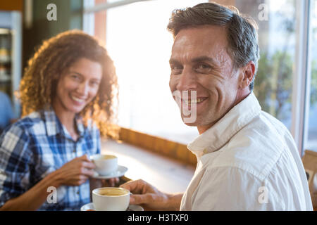 Couple having a cup of tea in supermarket Stock Photo