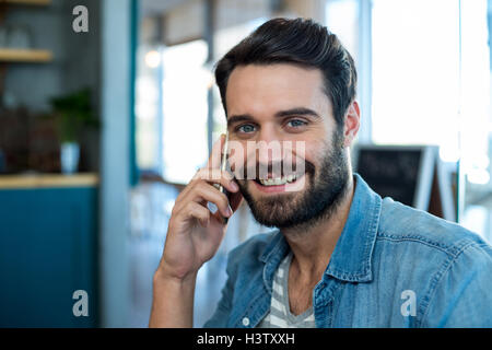 Smiling man talking on mobile phone Stock Photo