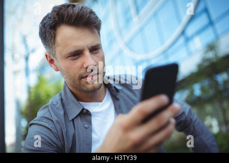 Handsome man using mobile phone Stock Photo