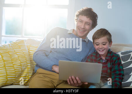 Father and son using laptop Stock Photo
