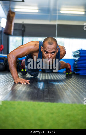 Determined man doing push-ups Stock Photo