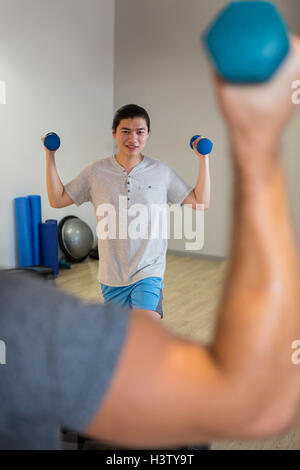 Man exercising on a step aerobic platform isolated on white background ...
