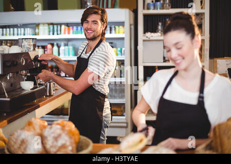 Waiter and waitress working behind the counter Stock Photo