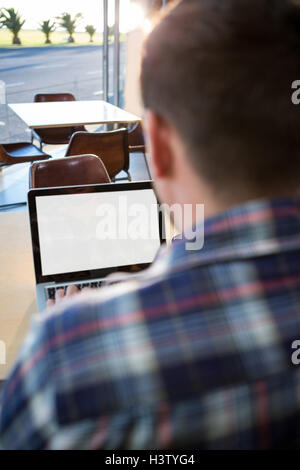 Rear view of man using his laptop Stock Photo