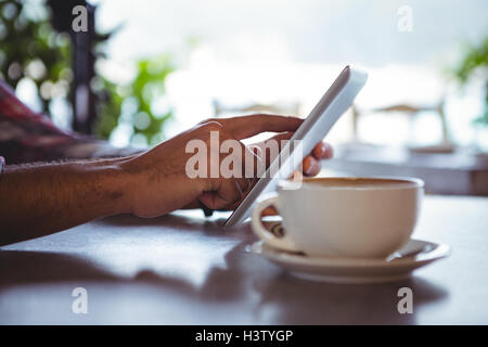Hands of man using digital tablet Stock Photo
