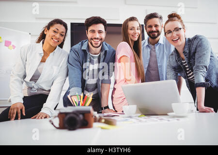 Portrait of cheerful editors standing at creative office Stock Photo